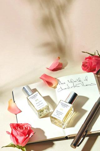 Image of two 15ml perfume, a pen and a notebook with Chandrika's Notes