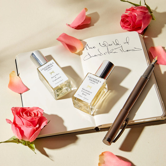 
  
    Image of pen and notebook with Chandrika's notes with two 15ml perfumes
  
